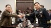 North Korean Lieutenant General An Ik San shakes hands with South Korean Major General Kim Do-gyun during a meeting at the Peace House of the border village of Panmunjom, South Korea, July 31, 2018. 