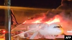 FILE - Fire authorities work to extinguish a fire that broke out on an Air Busan passenger plane at Gimhae International Airport in Busan on Jan. 28, 2025.
