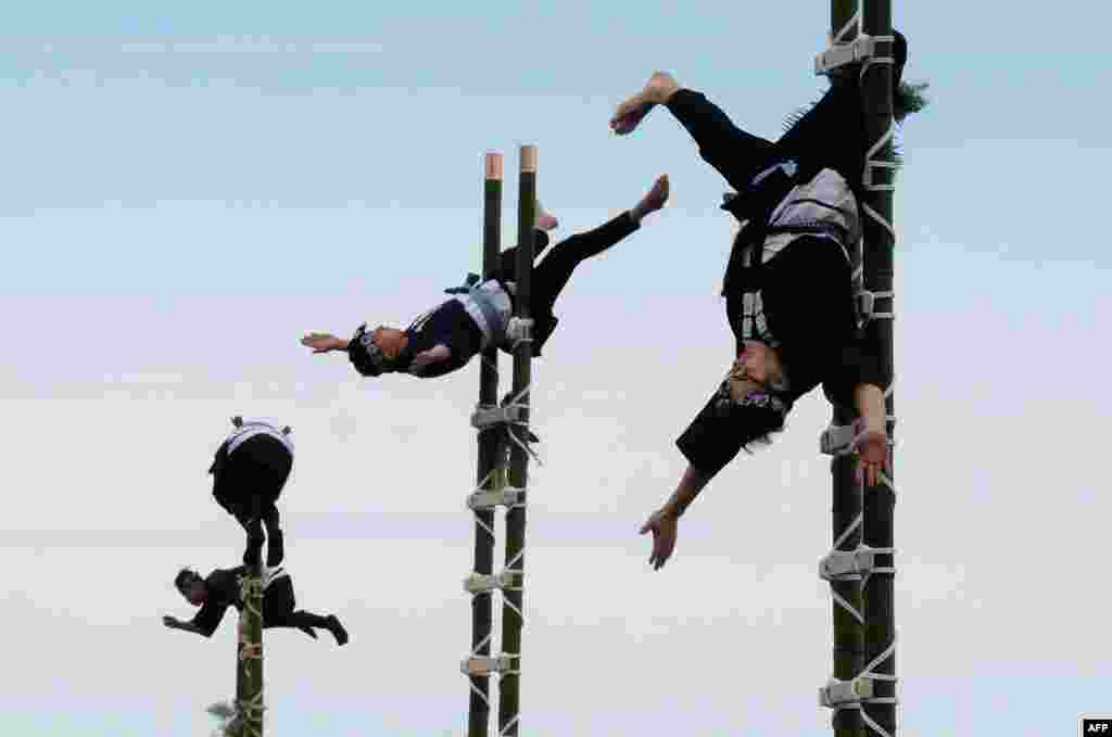 Members of the Edo Firemen Preservation Association perform Japanese traditional firefighting techniques during the New Year&#39;s fire brigades exercise in Tokyo.