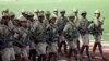 FILE - Eritrean soldiers march in Asmara, in May 2007. Eritrea's conscription system forces young people to complete their final year of high school in the desert town of Sawa at a facility that's part school, part boot camp.