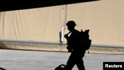 FILE - A U.S. soldier is seen during a handover ceremony of Taji military base from U.S.-led coalition troops to Iraqi security forces, in the base north of Baghdad, Iraq, Aug. 23, 2020. 