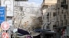 Debris fly as smoke rises following an Israeli air strike, amid Israeli-Palestinian fighting, in Khan Younis in the southern Gaza Strip, May 20, 2021.