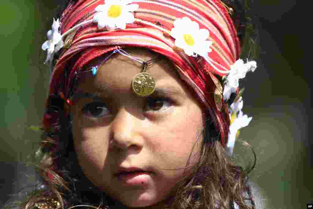 A Roma girl poses for photographers during celebrations for the 'Hidirellez' festival in Edirne, Turkey, near the Greek and Bulgarian borders. . The 'Hidirellez' festival attracts thousands to the celebration, marking the return of spring, with dancing, bonfires and bathing in the Tundzha River.