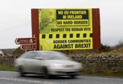 FILE - A car crosses over the border from the Irish Republic into Northern Ireland near the town of Jonesborough, Northern Ireland, Jan. 30, 2017.