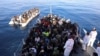 Migrants are seen in a rubber dinghy as they are met by the Libyan coast guard in the Mediterranean Sea off the coast of Libya, Jan. 15, 2018. 