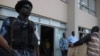 Togolese police forces stand guard at gate as electoral Commission members arrives with the ballot result papers on March 6, 2010 in Lome