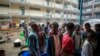 FILE - Displaced Tigrayans queue to receive food at the Hadnet General Secondary School, which has become a makeshift home to thousands displaced by the conflict, in Mekele, in the Tigray region of northern Ethiopia, May 5, 2021. 