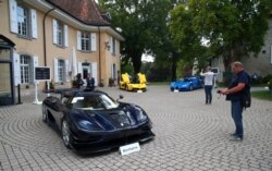 FILE - A Koenigsegg One:1, a Ferrari LaFerrari and a Bugatti Veyron EB 16.4 Coupe, part of a collection of luxury cars owned by Teodoro Obiang, confiscated a Swiss prosecutor in Geneva, Sept. 27, 2019.