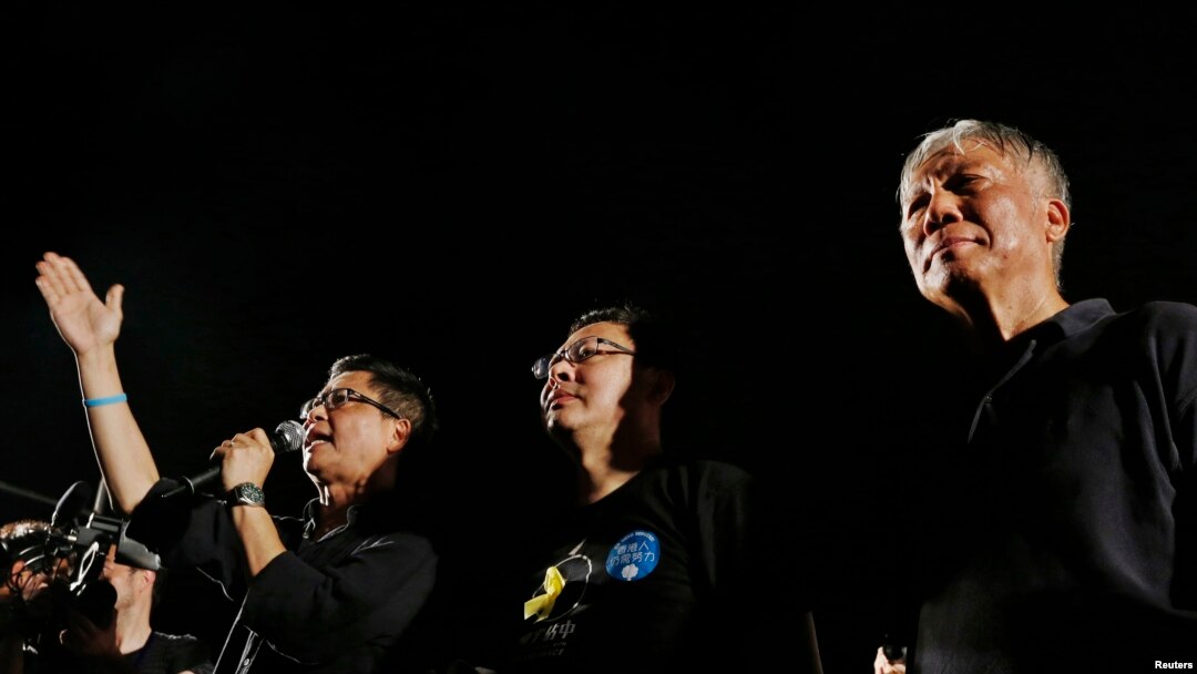 FILE - Founders of the Occupy Central civil disobedience movement, from left, Chan Kin-man, Benny Tai and Chu Yiu-ming, attend a campaign to kick off the movement in Hong Kong, Aug. 31, 2014. 