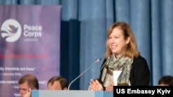 FILE - In this US State Department photo, Kristina Kvien speaks at a swearing-in ceremony for Peace Corps volunteers in Kyiv, Oct. 16, 2019.