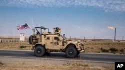 FILE - In this Oct. 28, 2019, file photo, U.S. forces patrol Syrian oil fields, in eastern Syria.