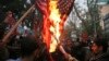 Hardline Iranian demonstrators burn representations of the U.S. flag during a gathering in front of the former U.S. Embassy in Tehran, May 9, 2018, reacting to President Donald Trump's decision to pull out of the nuclear deal.