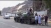 This frame grab from video shows fighters loyal to the separatist so-called Southern Transitional Council, backed by the United Arab Emirates, near the presidential palace, in Aden, Yemen, Jan. 30, 2018. 