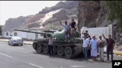 This frame grab from video shows fighters loyal to the separatist so-called Southern Transitional Council, backed by the United Arab Emirates, near the presidential palace, in Aden, Yemen, Jan. 30, 2018. 