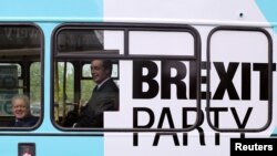 Brexit Party leader Nigel Farage and Mike Greene, Brexit Party candidate for the forthcoming Peterborough by-election, ride a campaign bus in Peterborough, Britain, May 9, 2019. 