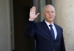 FILE - Tunisia's President Kais Saied waves before a meeting at the Elysee Palace in Paris, France, June 22, 2020.