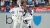 Los jardineros de los Dodgers de Los Ángeles, Andy Pages, Kevin Kiermaier y Mookie Betts, celebran su victoria contra los Mets de Nueva York en el Juego 1 de una Serie de Campeonato de la Liga Nacional de béisbol, el domingo 13 de octubre de 2024, en Los Ángeles. 