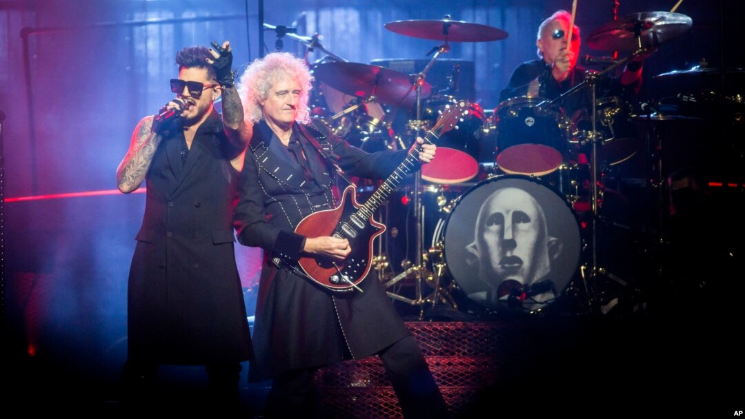 FILE - U.S. singer Adam Lambert performs with British guitarist Brian May (end-R) and drummer Roger Taylor from British rock band Queen during their concert in Papp Laszlo Budapest Sports Arena in Budapest, Hungary, Nov. 4, 2017.