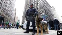 New York City Police K9 officer Kirk Boone and his police dog Kato keep their eyes and ears on crowds attending Super Bowl attractions on Broadway, Friday, Jan. 31, 2014 in New York. 