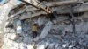 This photo provided by the Syrian Civil Defense White Helmets, which has been authenticated based on its contents and other AP reports, shows White Helmet civil defense workers after an explosion in north Syria, Aug. 12, 2018.