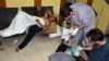People, affected by what activists say is nerve gas, are treated at a hospital in the Duma neighborhood of Damascus, August 21, 2013. 
