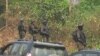 FILE - The military stands guard as government officials visit Lebialem, in southwest Cameroon, Sept. 15, 2018. Three village chiefs from Lebialem were murdered Feb. 13, 2021, by suspected rebels. 
