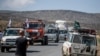 FILE - A convoy of trucks from Medecins Sans Frontieres carrying medical supplies stops by the side of the road after receiving news that the road ahead has been closed by the Ethiopian military, May 8, 2021.