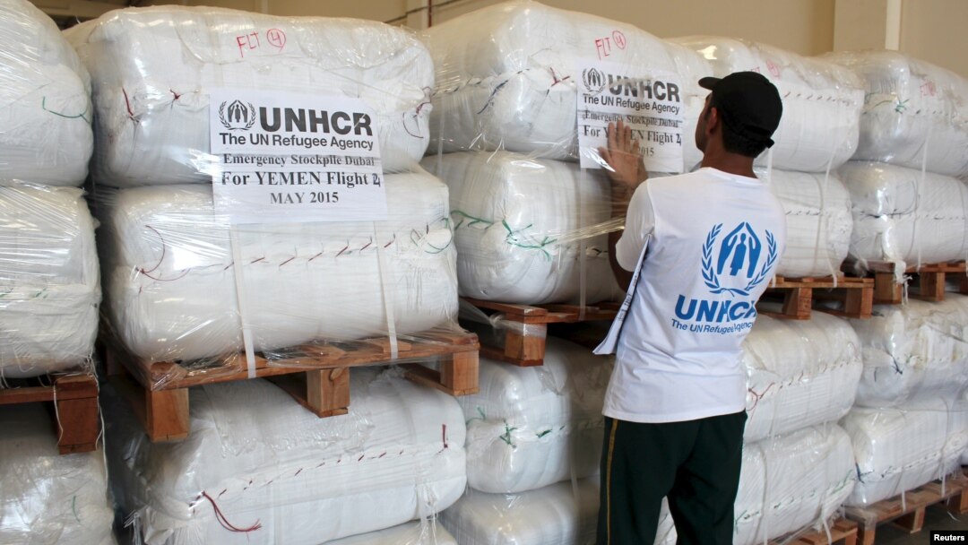 A UNHCR employee arranges aid at the Dubai International Humanitarian city in Dubai, United Arab Emirates, before shipping them to Yemen, May 14, 2015. 