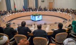 FILE - Participants attend talks between the Taliban and Afghan opposition representatives at the President Hotel, in Moscow, Russia, Feb. 5, 2019.