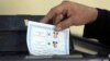 A woman casts her vote during the first day of the presidential election at a polling station in Cairo, Egypt, March 26, 2018.