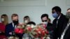 A Trump administration staffer wears a protective face mask in the Rose Garden as U.S. President Donald Trump holds a coronavirus disease (COVID-19) outbreak response briefing at the White House in Washington, May 11, 2020.