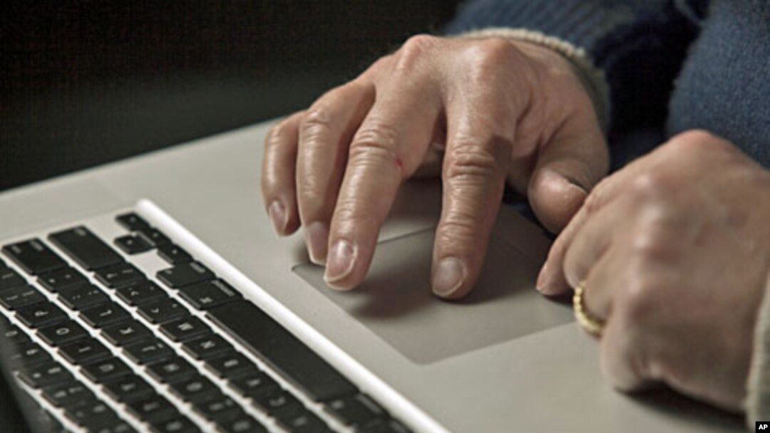 A cyber warfare expert works on his laptop computer in Charlotte, North Carolina, December 1, 2011.