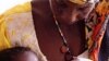 Mother feeding her severely malnourished daughter at centre run by CONCERN and supported by WFP