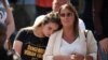FILE - Members of the public gather outside Manchester Cathedral on May 22, 2018, the one year anniversary of the deadly attack at Manchester Arena.