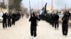 FILE - This undated file image posted on a militant website on Tuesday, Jan. 14, 2014, which has been verified and is consistent with other AP reporting, shows fighters from the al-Qaida linked Islamic State of Iraq and the Levant (ISIL) marching in Raqqa, Syria. Moderate Syrian rebels are buckling under the onslaught of the radical al-Qaida breakaway group that has swept over large parts of Iraq and Syria. Some rebels are giving up the fight, crippled by lack of weapons and frustrated with the power of the Islamic State of Iraq and the Levant. Other, more hard-line Syrian fighters are bending to the winds and joining the radicals. (AP Photo/Militant Website, File)