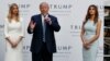 Republican presidential candidate Donald Trump, accompanied by, from left, Ivanka Trump and Melania Trump, speaks during grand opening of Trump International Hotel-Old Post Office, Oct. 26, 2016, in Washington.