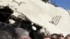 UN Secretary General Ban Ki-moon, centre, visits a destroyed house in Jebaliya, northern Gaza Strip, Sunday, March 21, 2010. U.N. chief Ban Ki-moon has entered the blockaded Gaza Strip, where 1.5 million people have been under lockdown by Israel and Egypt