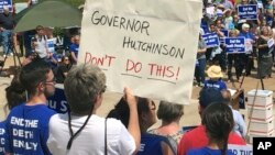 Protesters gather outside the state Capitol building, April 14, 2017, in Little Rock, Ark., to voice their opposition to Arkansas' upcoming executions.