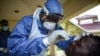 FILE - A medical officer takes a sample for COVID-19 at the laboratory of Kenya Medical Research Institute (KEMRI) in Kisumu, western Kenya, Apr. 23, 2020.
