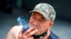 FILE - A man smokes in Auckland, New Zealand, Dec. 9, 2021. 