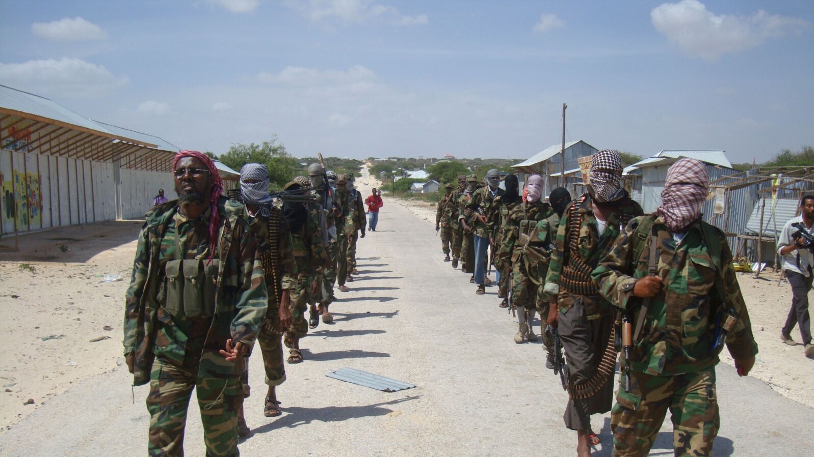 FILE - Members of Somalia's al-Shabab militant group march on the outskirts of Mogadishu, Somalia, March, 5, 2012. 