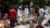 FILE - People wait to get food distributed by volunteers in Omdurman, Sudan, on Sept. 3, 2023.