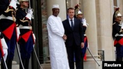 FILE - French President Emmanuel Macron welcomes Chadian President Idriss Déby as he arrives to attend an international conference on Libya at the Elysee Palace in Paris, May 29, 2018. 