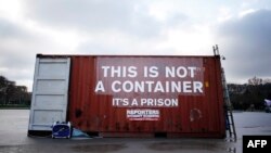 FILE - A shipping container stands in position during a demonstration by the press freedoms organization Reports Sans Frontier (Reporters Without Borders) in Paris, Dec. 16, 2014. Reports from inside Eritrea describe inhumane conditions where prisoners are held in shipping crates in the desert.
