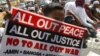 A Filipino Muslim flashes the peace sign as he holds a placard during a 'Prayer-for-Peace' rally near the Presidential Palace in Manila, Philippines, October 28, 2011. 